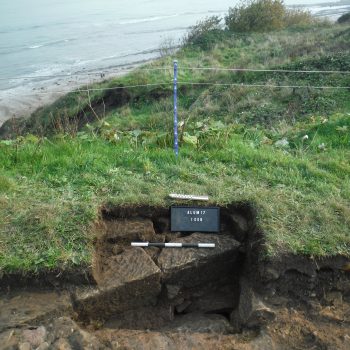 Trench 1 showing the western elevation of a double-skinned sandstone wall.