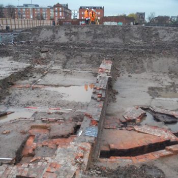 A chimney foundation and flue system revealed during evaluation trenching in Manchester. © Copyright ARS Ltd 2018