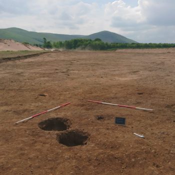 One of the pit clusters, with Yeavering Bell in the background (scales = 2 x 2m).