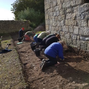 Volunteers excavating at the foot of the Pele Tower in 2018.