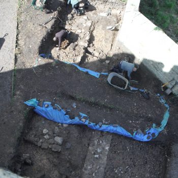 The pre-Pele Tower building is visible in the left hand side of the photo with the drain running into it on the right side of the building.