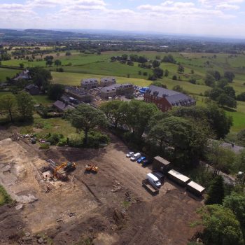 Aerial view of the entire site with Bleaklow Mill visible beyond the trees.