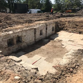 A view of the cellar with storage alcoves in the back wall and high-quality paved floor.