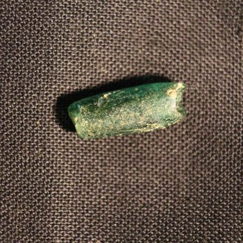 A Romano-British glass bead recovered from the Roman vicus at Hope Quarry.