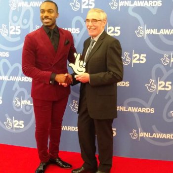 Barry being presented with the Local Legend Award by BBC presenter Ore Oduba.