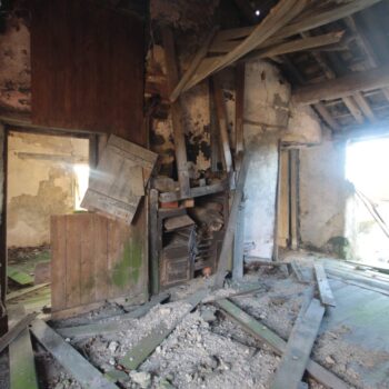 An oblique view of the southern interior wall within the eastern wing's central first floor room. The photograph shows the central range flanked by two doors to the Hardy extension. © Copyright ARS Ltd 2021.