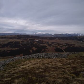 View of the SE rampart of Yeavering Bell hillfort across the northern Cheviots. © Copyright ARS Ltd 2021.