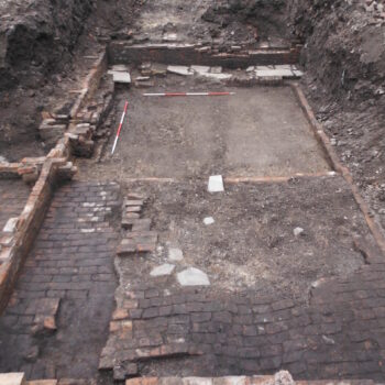 View of one of the two-roomed cellar dwellings in a row of early 19th century back-to-back houses. The remails of a raised, secondary brick floor can be seen in one room which was installed in the late 19th century © Copyright ARS Ltd 2022