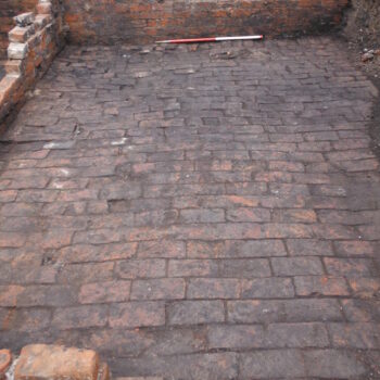 View showing that internal partition walls of the cellar dwellings were one brick wide. A small red-brick structure was added to the outer wall which probably served as a light well enabling some natural light to enter into the underground room © Copyright ARS Ltd 2022